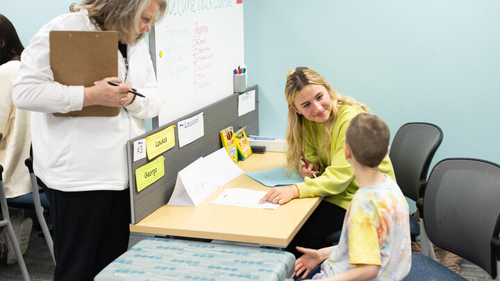 Addie Olson (center), a senior elementary education major, works with a student in the Kit and Dick Schmoker Reading Center on Feb. 24 as Susan Dinsdale (left), a supervisor, observes.