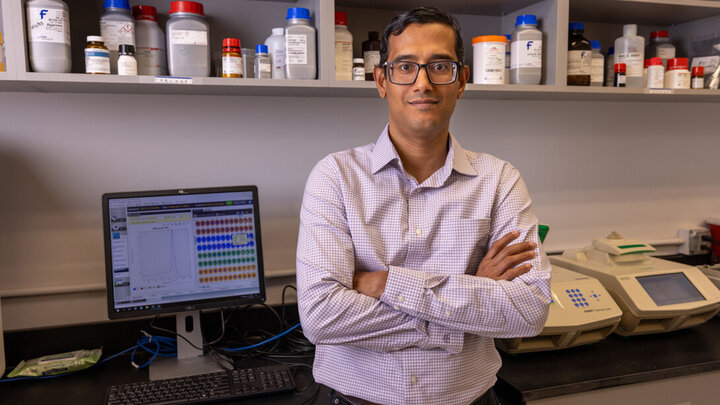 Sunil Sukumaran stands for a photo in his research lab