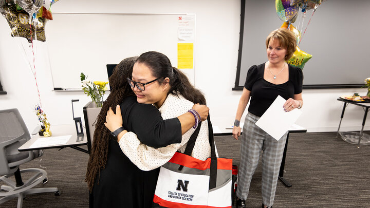 Rachawadee Maungkya-Taveepanpun hugs Barb Miller as Sue Kemp looks on