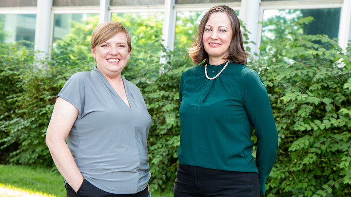 Amanda Prokasky and Lorey Wheeler stand side-by-side outside a building