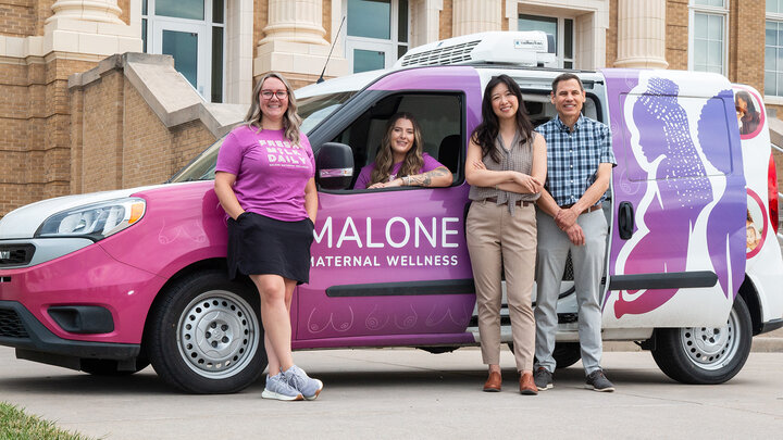 From left, Malone Maternal Wellness’ Jillian Boldt and Jordan Hardesty, and Nebraska researchers Patty Kuo and Alex Mason, check out the Malone Milk Mobile. (Kyleigh Skaggs, CYFS)