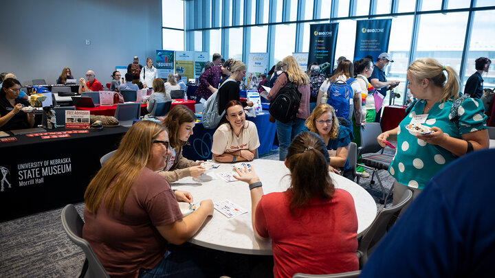 participants of the Nebraska Association of Teachers of Science conference socialize during a poser and vendor session