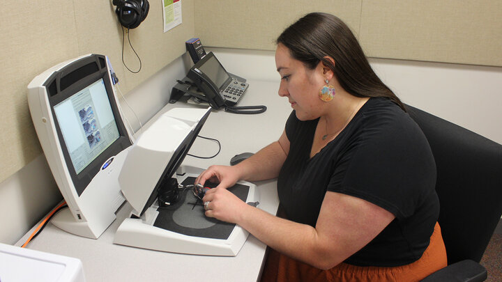 Alli Durnal prepares to measure and program a hearing aid using a Verifit system at the Barkley Speech Language and Hearing Clinic.