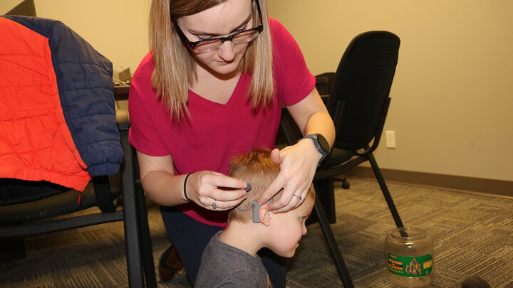 Husker audiology student clinician works with a child with a cochlear implant