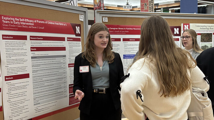 Grace Fowler discusses her research poster at Student Research Days in April 2024