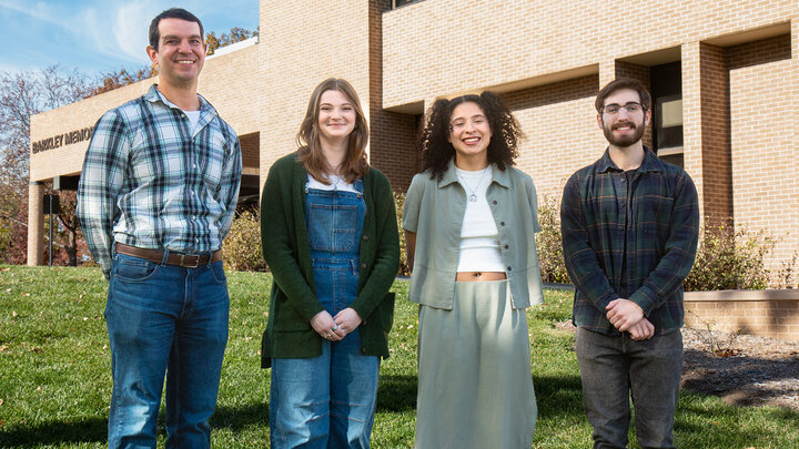 Kevin Pitt, Grace Fowler, Elena Butler and James Sawall stand outside the Barkley Memorial Center for a research team photo 