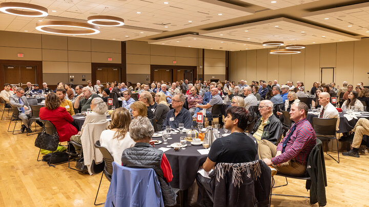 donors, students, faculty and staff sit at tables in a large room for the 2025 scholarship donor luncheon