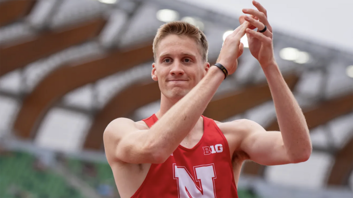 Tyus Wilson claps after a high jump attempt in his Husker uniform