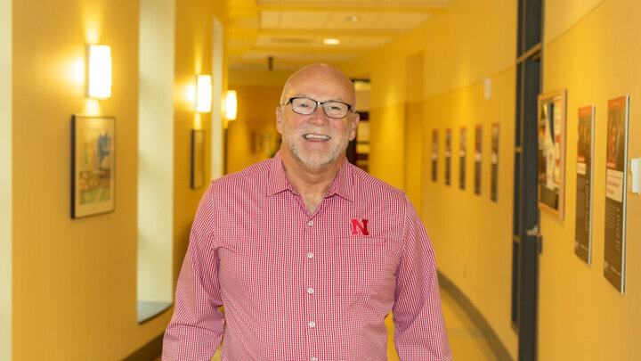 Don Johnson stands in the hallway of Teachers College Hall