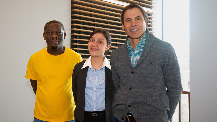graduate research assistants Deogratias Musoke and Ni Ketut Wilmayani pose for a photo with Alex Mason, professor of child, youth and family studies