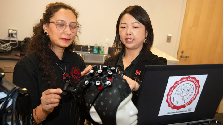 Yingying Wang, resident faculty of the Center for Brain, Biology and Behavior (CB3) and director of the Neuroimaging for Language, Literacy and Learning Lab (NL3), right, works with graduate research assistant Dania Javaid.