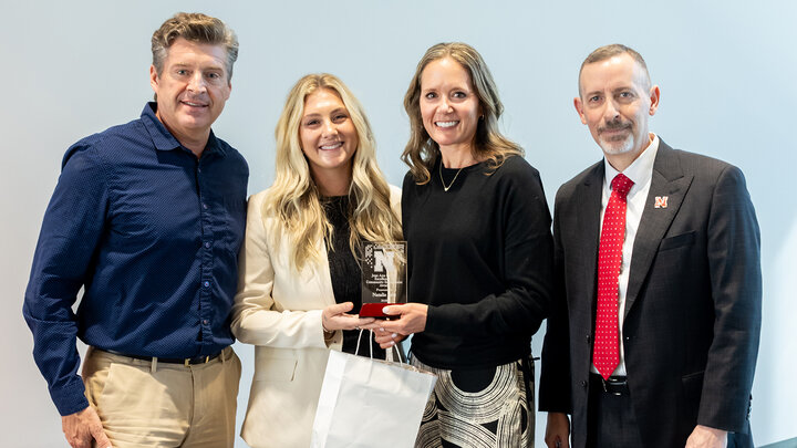 Jerry Fischer, Carson Fischer-Samway and Jeff Reese (far right) present the Jean Ann Fischer Excellence in Community Engagement Award to Natalie Sehi (third from left).
