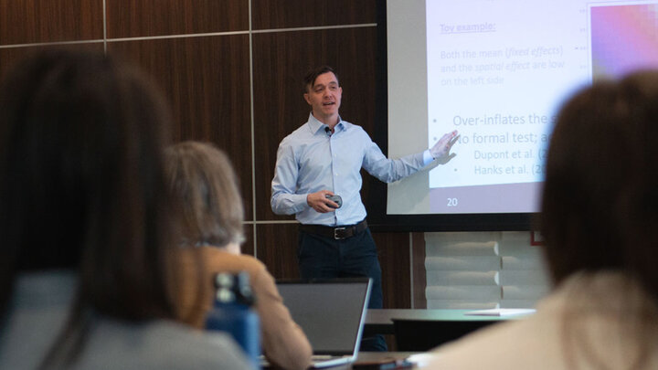 Pavel Chernyavskiy points to a screen while leading the April 24 Methodology Applications Series presentation at the Nebraska Union.