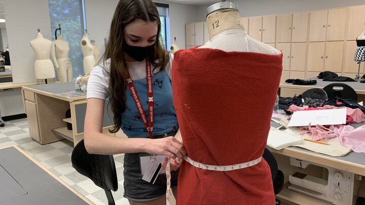 Student designing a fashion garment. 