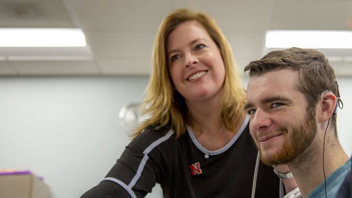 Michelle Hughes smiles as she works with a patient. 