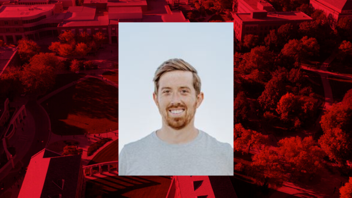 Professional headshot of Jeff Nilsen on a red background. 