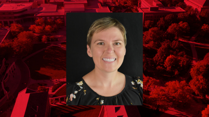 Headshot of Kristin Malek on a red background. 