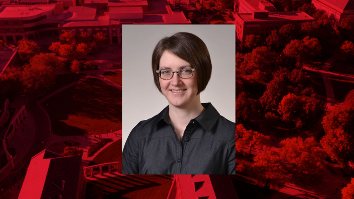Professional headshot on red background. 