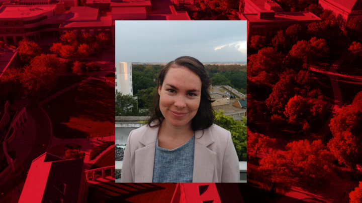 Profile photo of an individual in an outdoor setting. The photo is placed on a red background