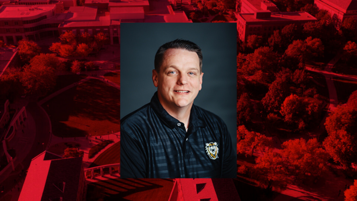 Professional headshot of Scott Gregory on a red background.