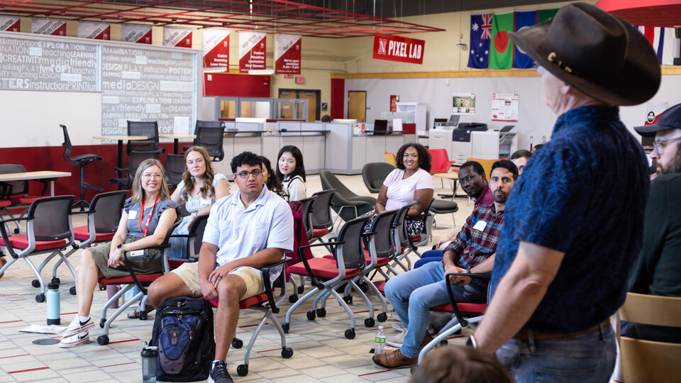 A group of students listening to a speaker. 