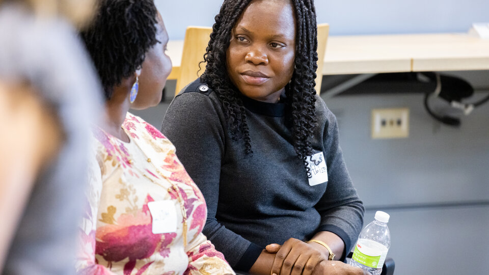A student and professor speaking with each other. 
