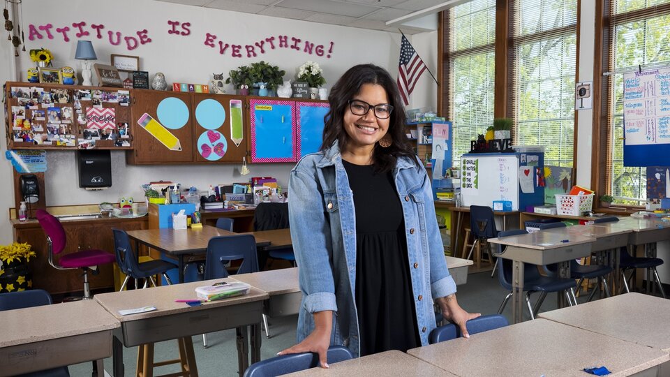 Teacher Standing in Classroom