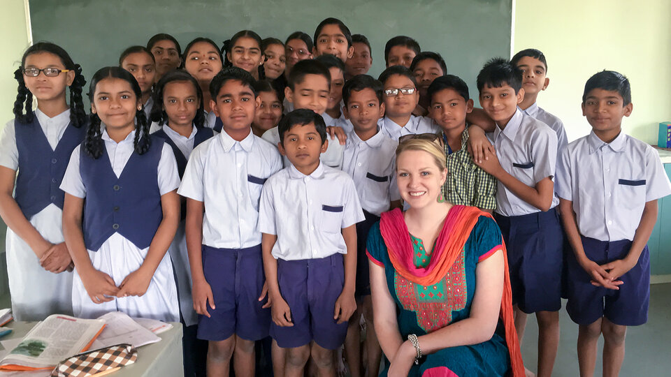 International teacher with a group of students