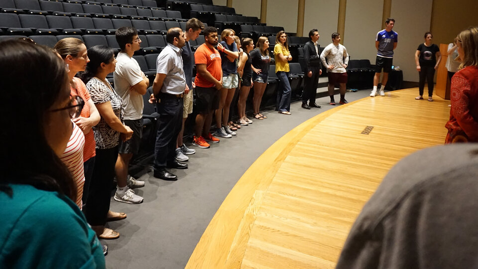 Group of people around stage.