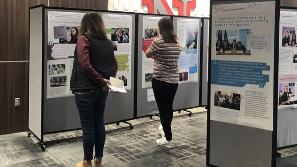 Students looking at research poster displays