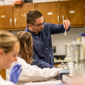 Assistant Professor Ivan Vechetti works alongside two students in his research lab