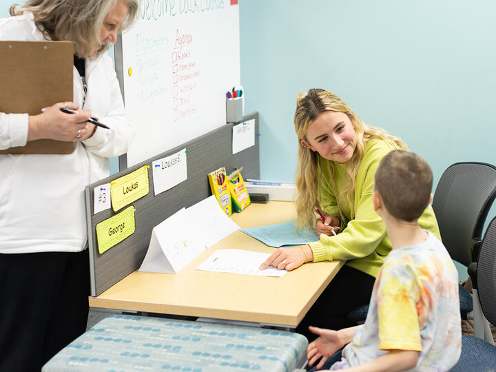 Addie Olson (center), a senior elementary education major, works with a student in the Kit and Dick Schmoker Reading Center on Feb. 24 as Susan Dinsdale (left), a supervisor, observes.