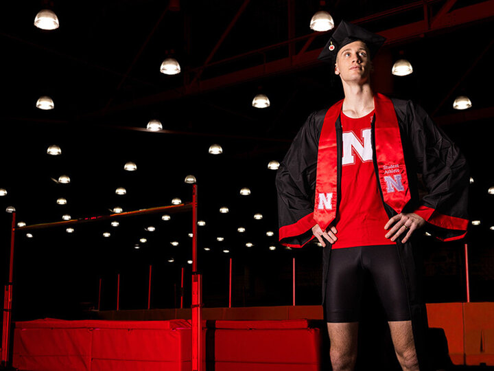 Tyus Wilson, a senior graduating with a degree in elementary education and high-jumper for the Husker Track and Field team, poses for a portrait inside the Devaney Center Indoor Track.