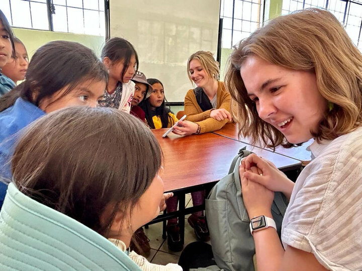 Women talking with immigrant kids.