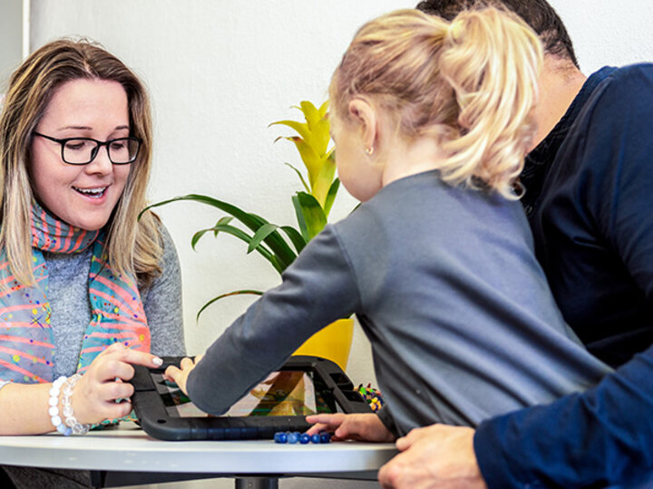 Instructor and child looking at a tablet computer.