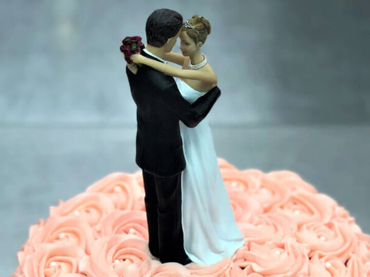 Bride and Groom figures on a cake top.