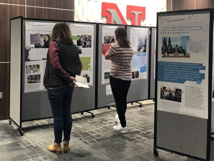 Students looking at research poster displays