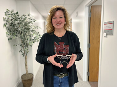 Jill England holding staff star award.