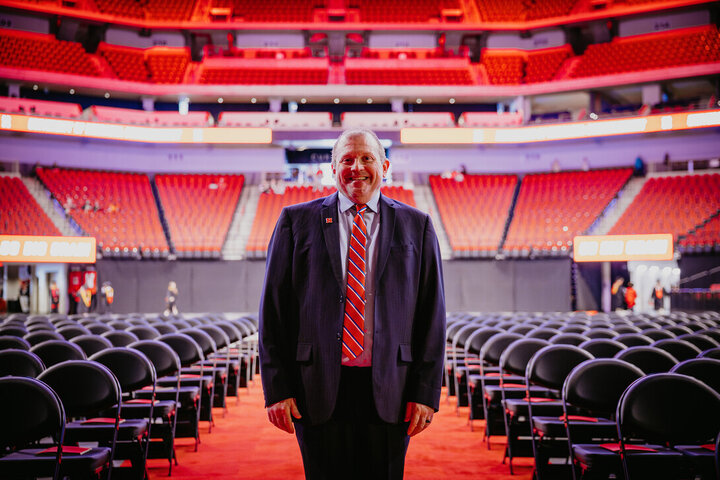 Corrie Svehla poses in the aisle as Pinnacle Bank Arena was being prepared for the May 2025 ceremonies.