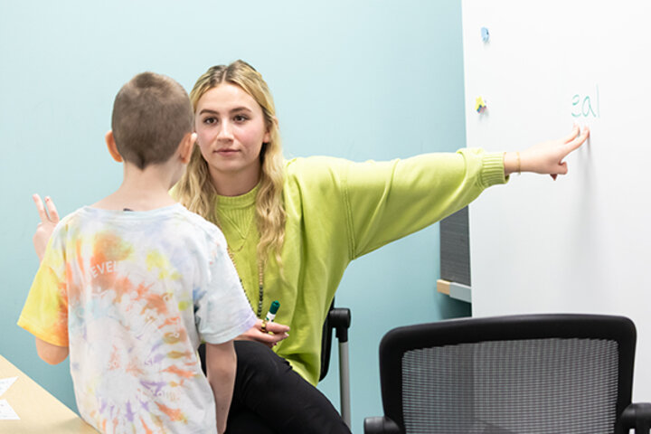 a student tutors a young child at the Schmoker Reading Center
