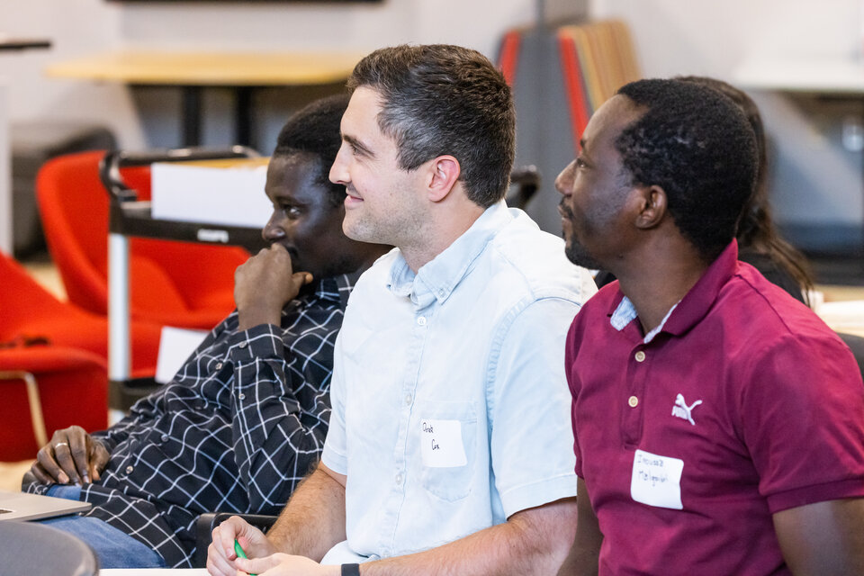 A group of students listening to a speaker. 