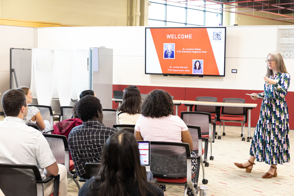 A group of students listening to a speaker. 