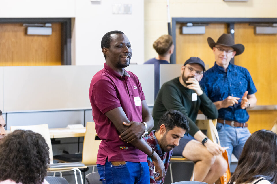 A group of people listening to a speaker. 