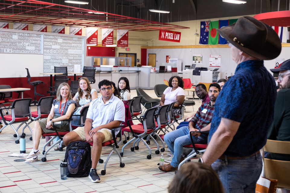 A group of students listening to a speaker. 