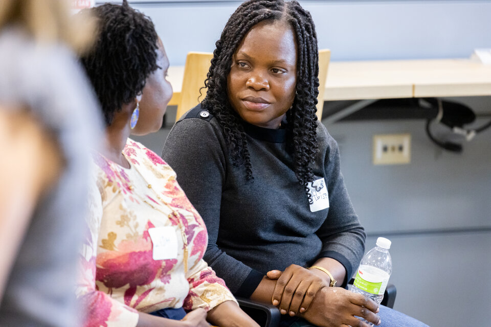 A student and professor speaking with each other. 