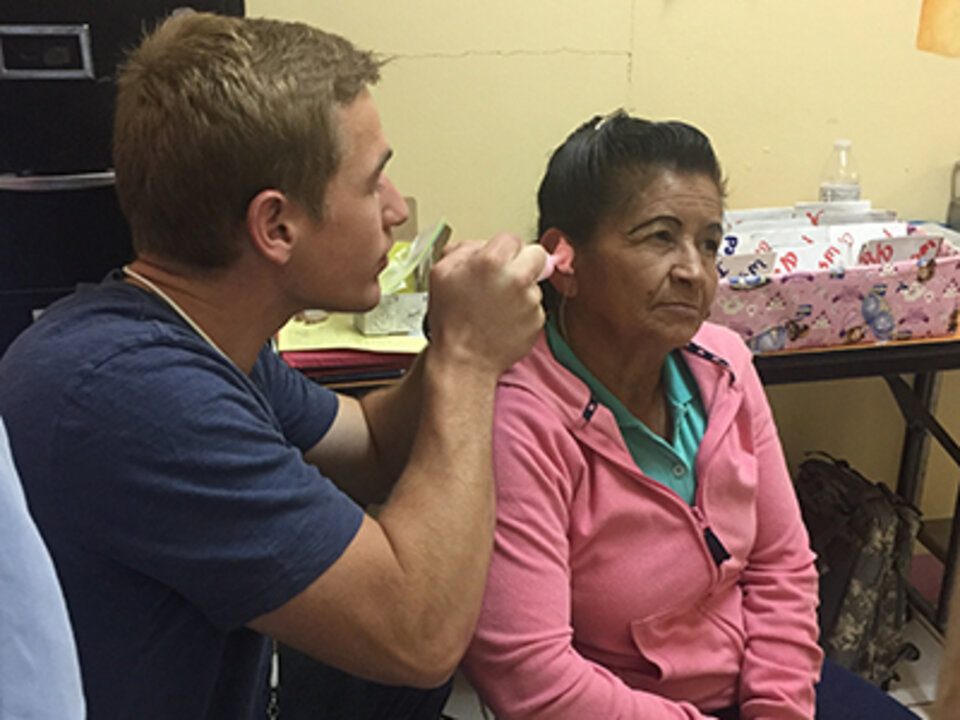 clinician looking in womans ear.