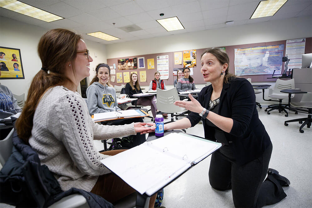 Cynthia Cress doing hands-on work with students