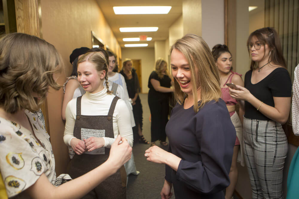 Jennifer Jorgensen with students backstage at fashion show