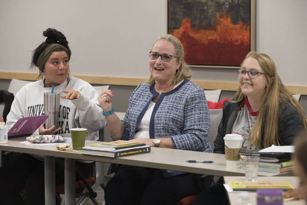 Sheree Moser laughs with class during discussion